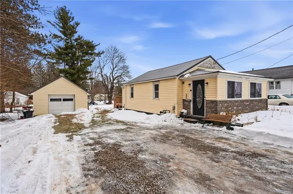 a view of a house with a yard covered in snow