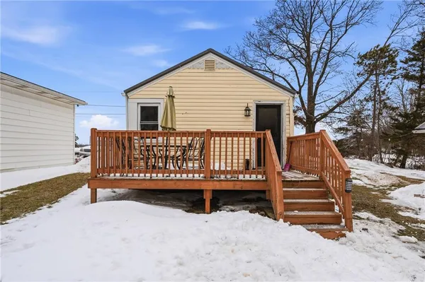a view of a house with wooden fence in front of house