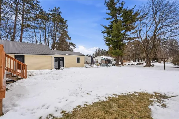 a view of backyard with a patio and snow