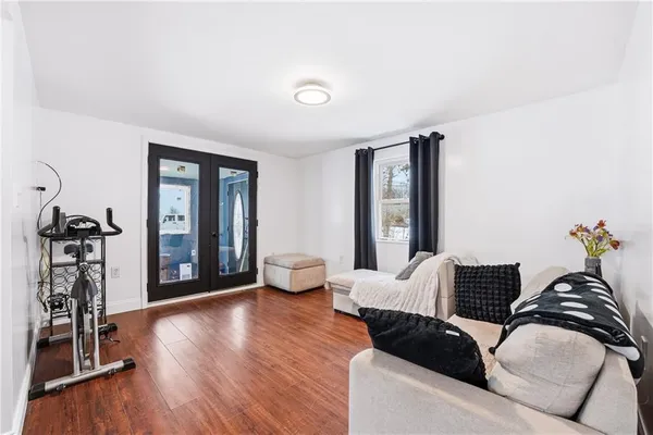 a living room with furniture and wooden floor