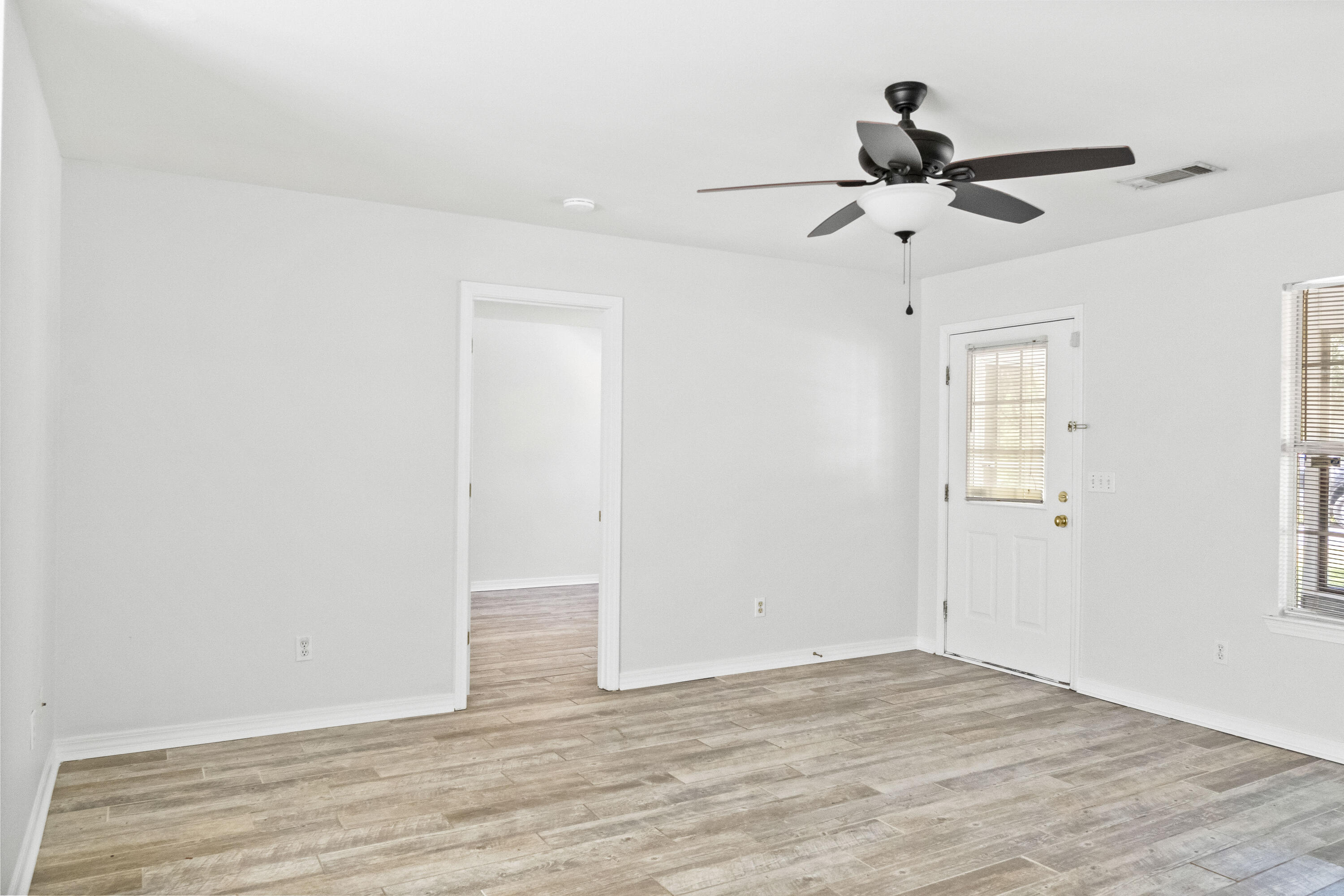 56 Kimberly Ann Drive Santa Rosa Beach, FL 32459 - Photo 15 of 39 a view of empty room with wooden floor and ceiling fan