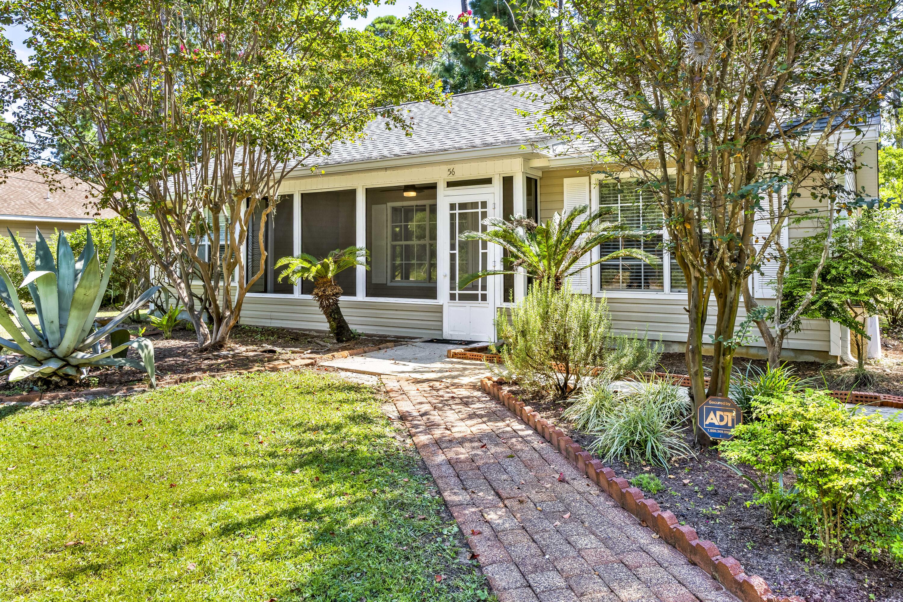 56 Kimberly Ann Drive Santa Rosa Beach, FL 32459 - Photo 3 of 39 a front view of a house with garden
