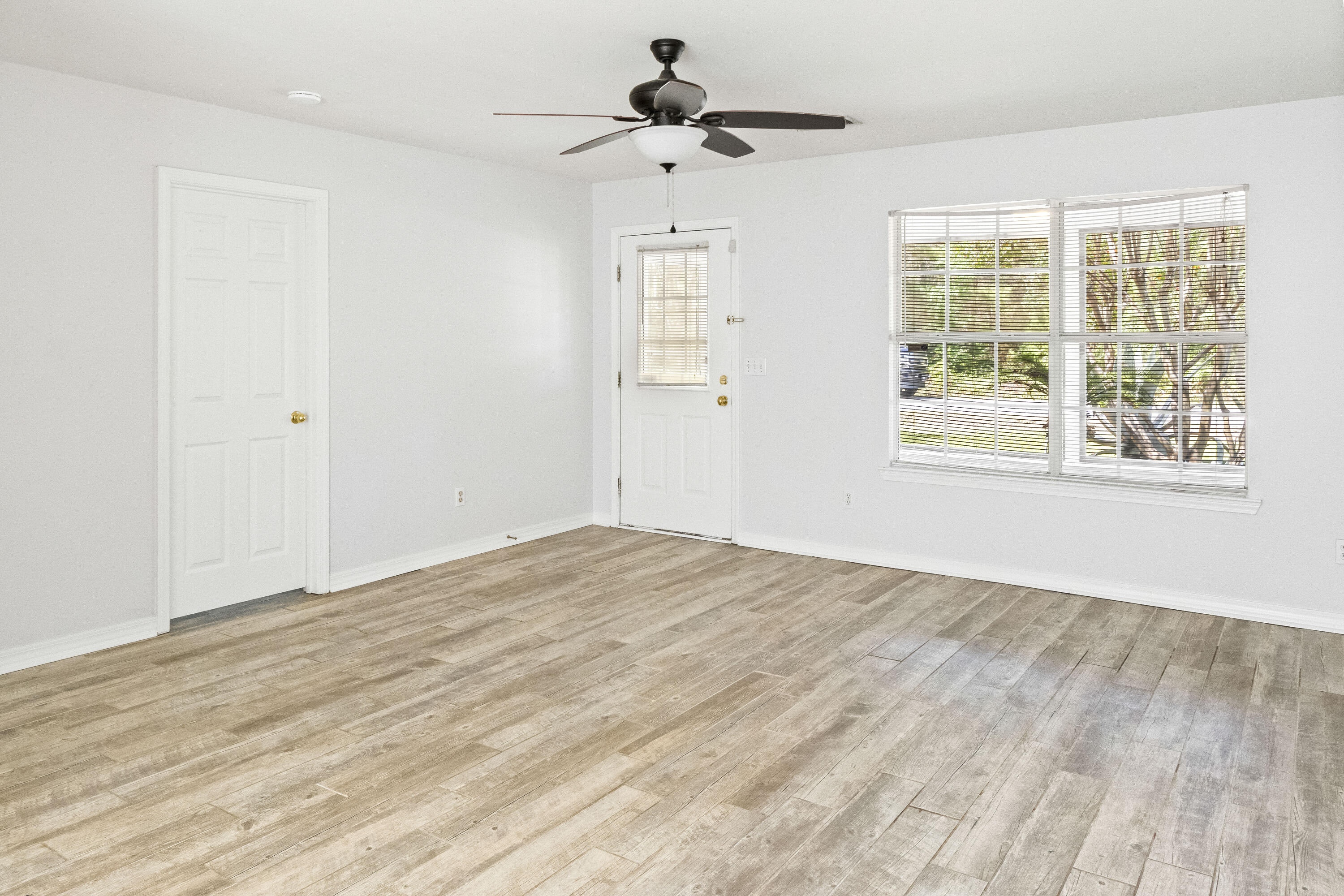 56 Kimberly Ann Drive Santa Rosa Beach, FL 32459 - Photo 6 of 39 a view of empty room with wooden floor and fan