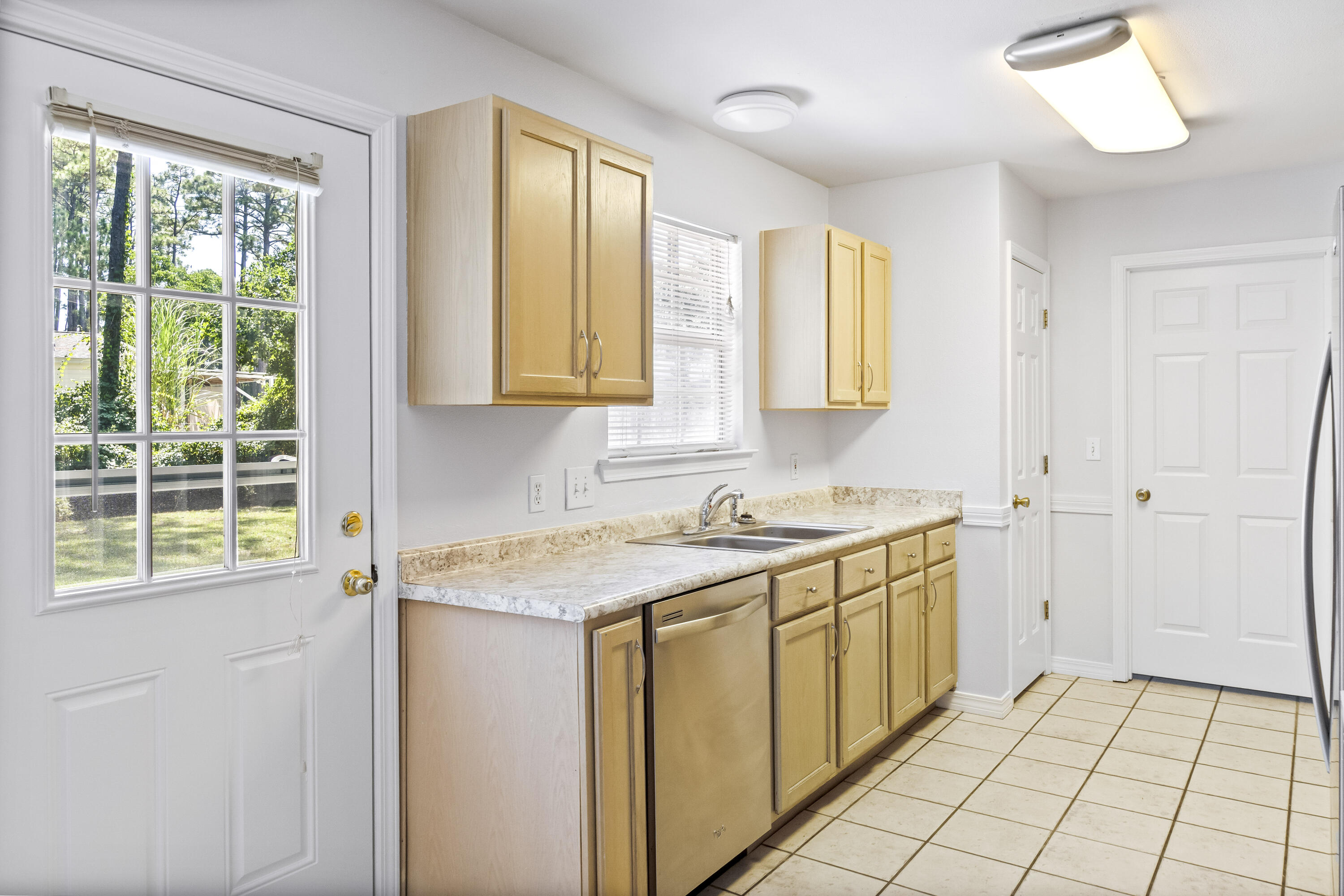 56 Kimberly Ann Drive Santa Rosa Beach, FL 32459 - Photo 10 of 39 a view of a kitchen with a sink and dishwasher next to a window