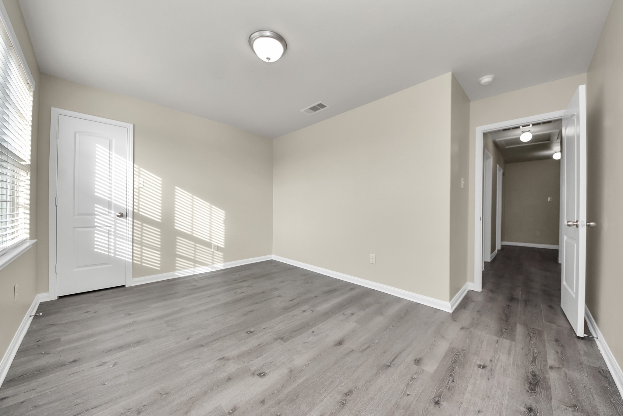 1855 Garnet Breeze Drive Rosharon, TX 77583 - Photo 37 of 40 a view of an empty room with wooden floor and a window