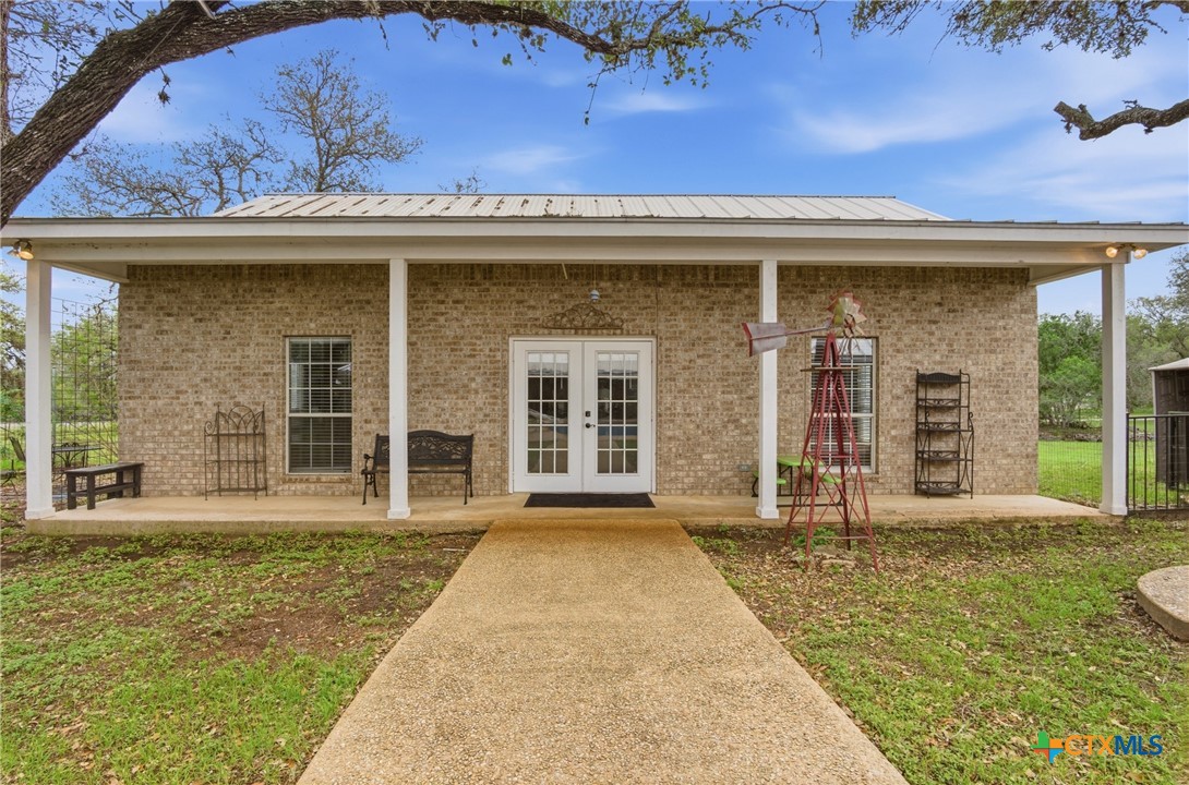 642 Phantom Rider Trail Spring Branch, TX 78070 - Photo 28 of 41 a view of a house with large windows and plants