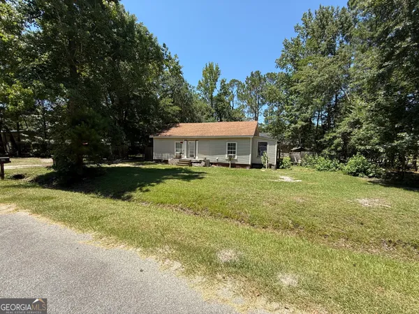 a view of house with garden space and trees