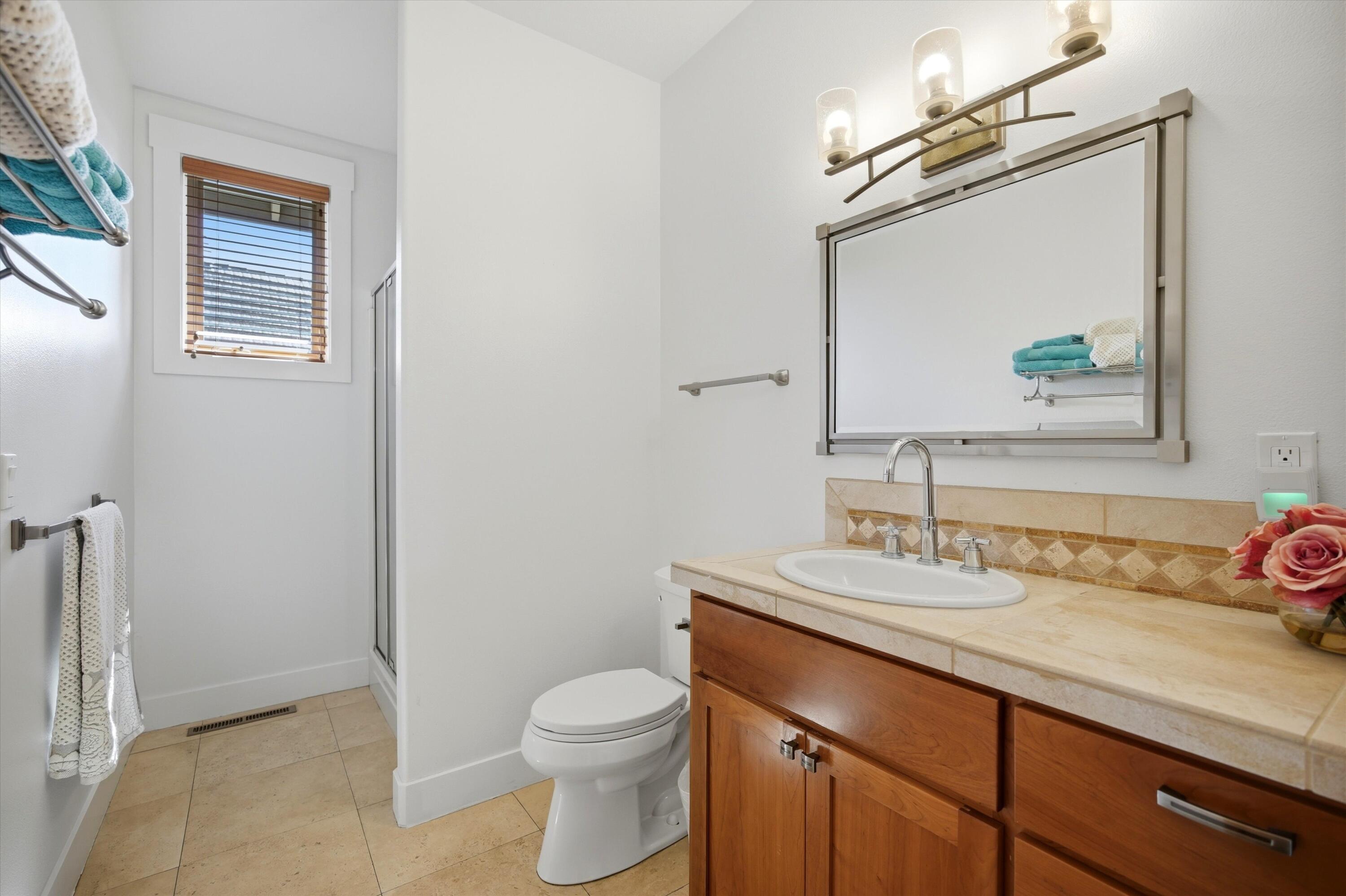 15 Southwest Quail Butte Place Bend, OR 97703 - Photo 31 of 55 a bathroom with a toilet sink and mirror