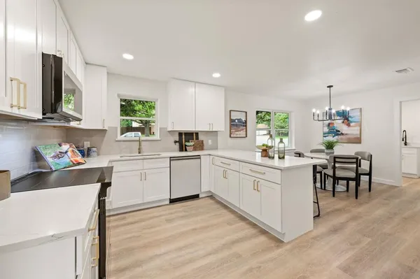 a kitchen with a sink cabinets and window