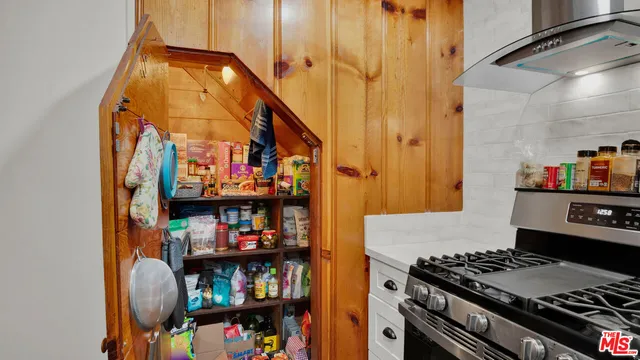 a kitchen with stainless steel appliances granite countertop a stove and a more cabinets