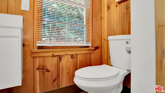 a bathroom with a toilet a sink and a window