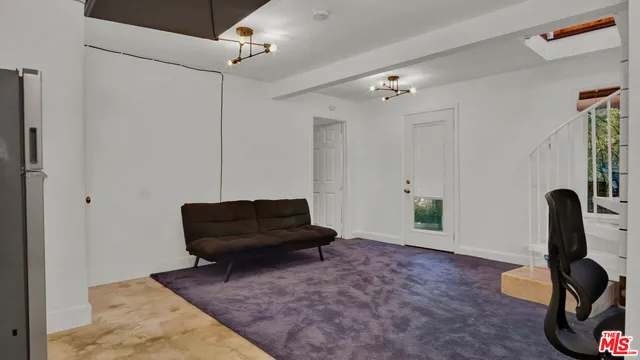 a bedroom with a bed and a wooden floor