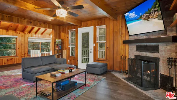 a living room with furniture a fireplace and a flat screen tv