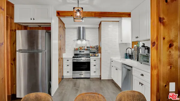 a kitchen with stainless steel appliances a refrigerator and cabinets