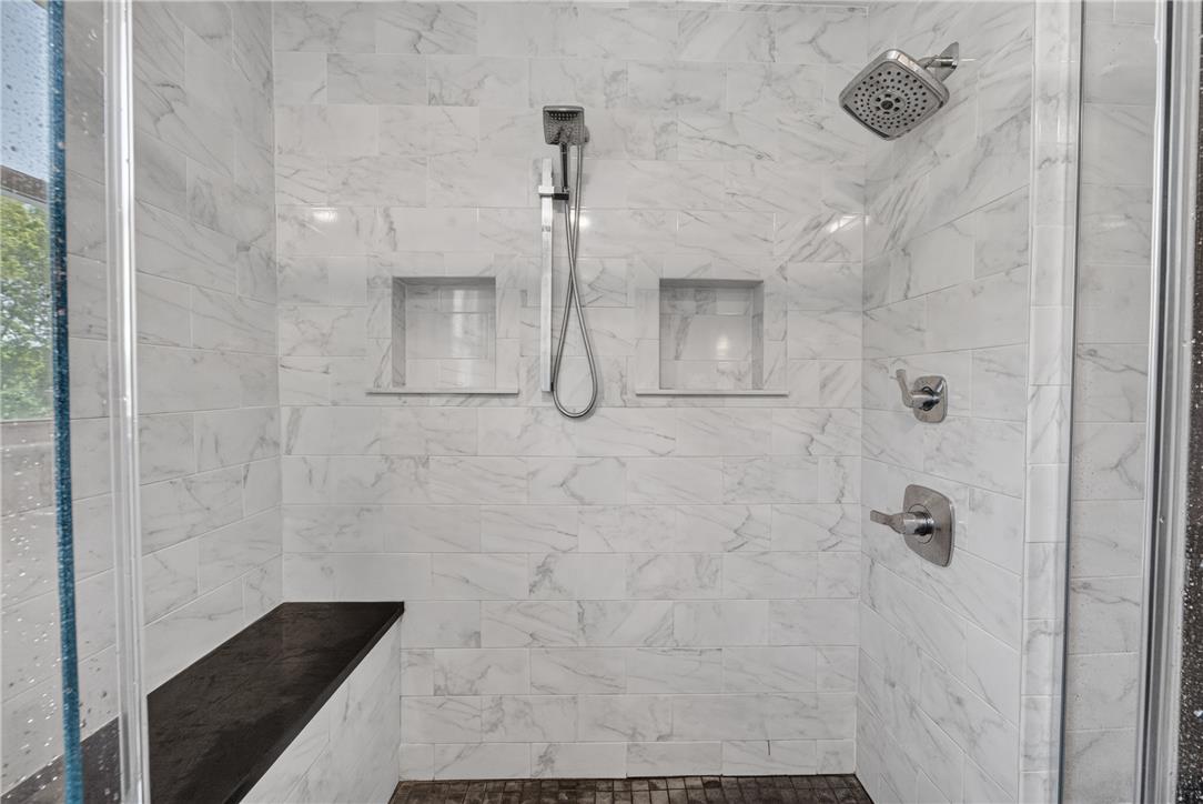 220 Pennbrook Road Stroudsburg, PA 18360 - Photo 30 of 60 Marble-tiled shower with convenient built-in shelving and a modern showerhead system.
