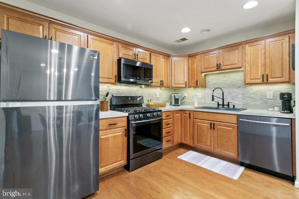 220 Flagstone Road, Unit 6 Chester Springs, PA 19425 - Photo 11 of 32 a kitchen with stainless steel appliances granite countertop a refrigerator stove microwave and sink