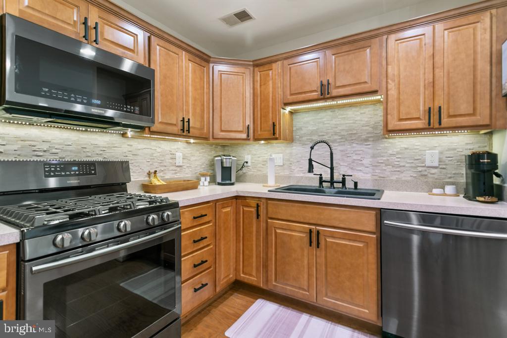 220 Flagstone Road, Unit 6 Chester Springs, PA 19425 - Photo 12 of 32 a kitchen with stainless steel appliances a sink a stove and microwave