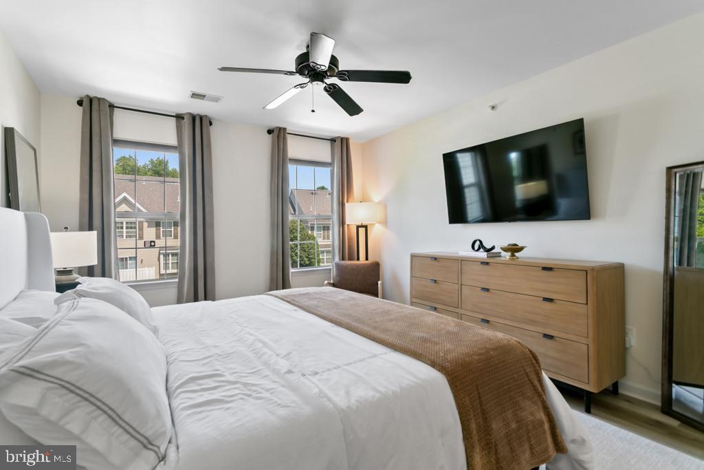 220 Flagstone Road, Unit 6 Chester Springs, PA 19425 - Photo 16 of 32 a bedroom with a large bed and a flat screen tv