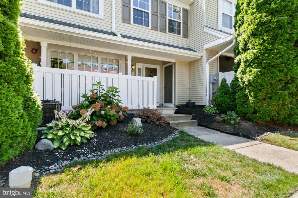 220 Flagstone Road, Unit 6 Chester Springs, PA 19425 - Photo 2 of 32 a front view of a house with a yard and porch