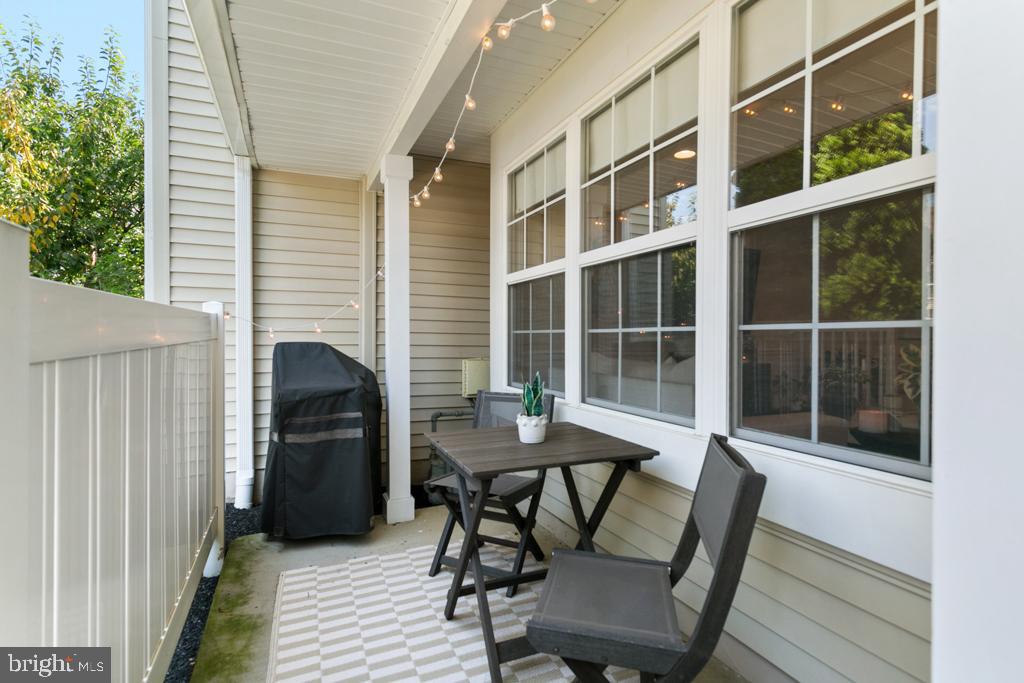 220 Flagstone Road, Unit 6 Chester Springs, PA 19425 - Photo 3 of 32 a view of a deck with table and chairs and wooden floor