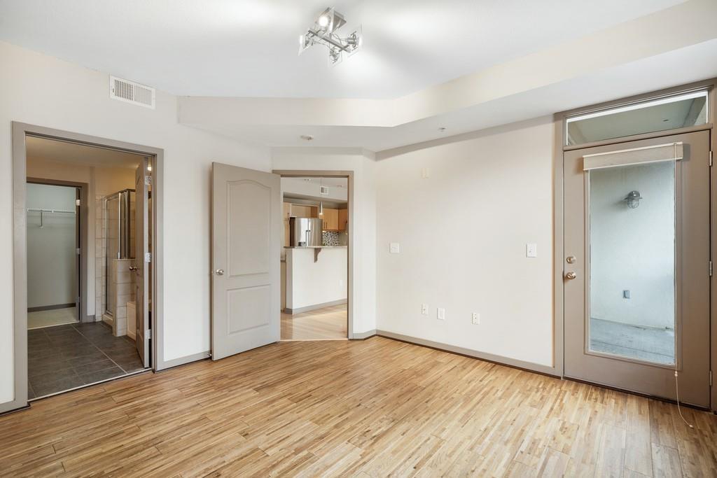 390 17th Street Northwest, Unit 3044 Atlanta, GA 30363 - Photo 11 of 31 wooden floor in an empty room with a window