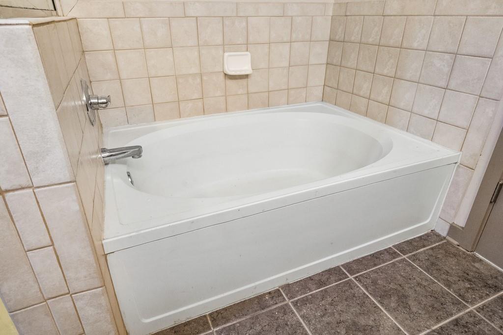 390 17th Street Northwest, Unit 3044 Atlanta, GA 30363 - Photo 15 of 31 a white bath tub sitting in a bathroom