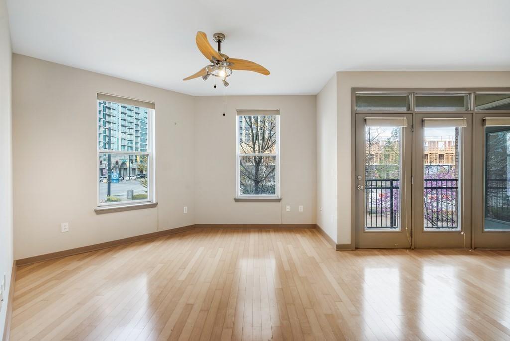 390 17th Street Northwest, Unit 3044 Atlanta, GA 30363 - Photo 2 of 31 a view of an empty room with a window and wooden floor