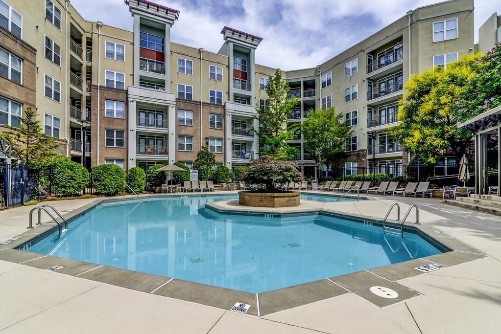 390 17th Street Northwest, Unit 3044 Atlanta, GA 30363 - Photo 27 of 31 a view of a swimming pool with a lounge chairs