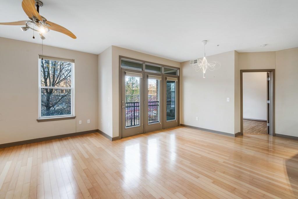 390 17th Street Northwest, Unit 3044 Atlanta, GA 30363 - Photo 6 of 31 a view of an empty room with glass door and wooden floor