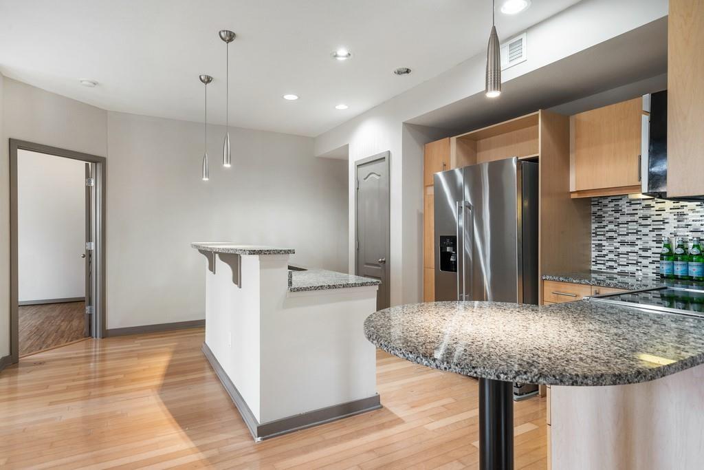 390 17th Street Northwest, Unit 3044 Atlanta, GA 30363 - Photo 8 of 31 a kitchen with stainless steel appliances granite countertop a kitchen island a refrigerator and a stove