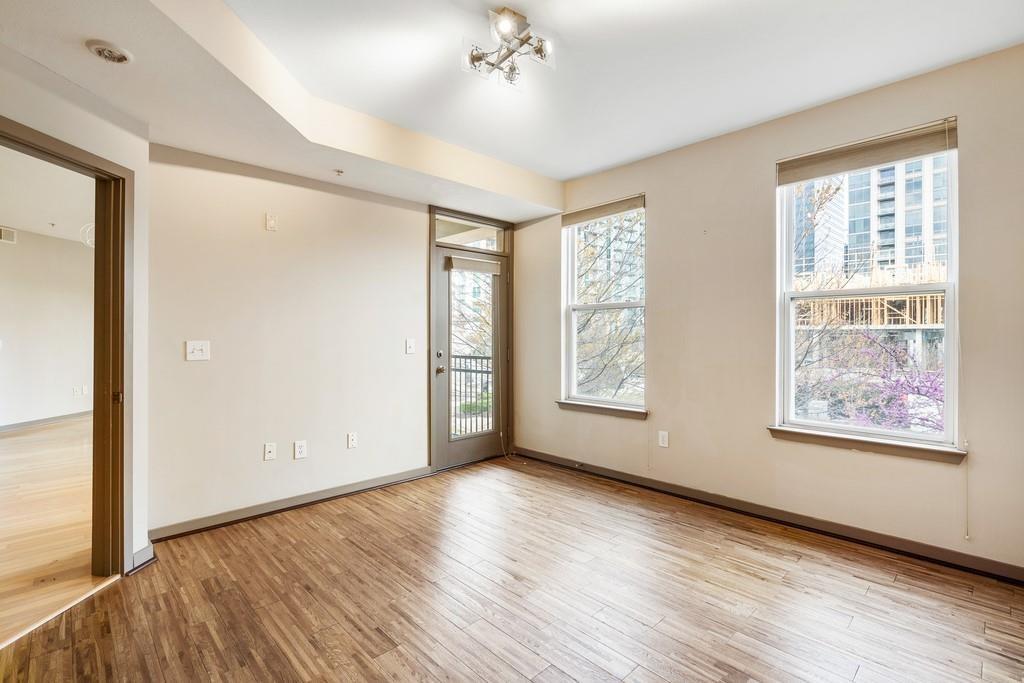 390 17th Street Northwest, Unit 3044 Atlanta, GA 30363 - Photo 10 of 31 a view of an empty room with a window and wooden floor
