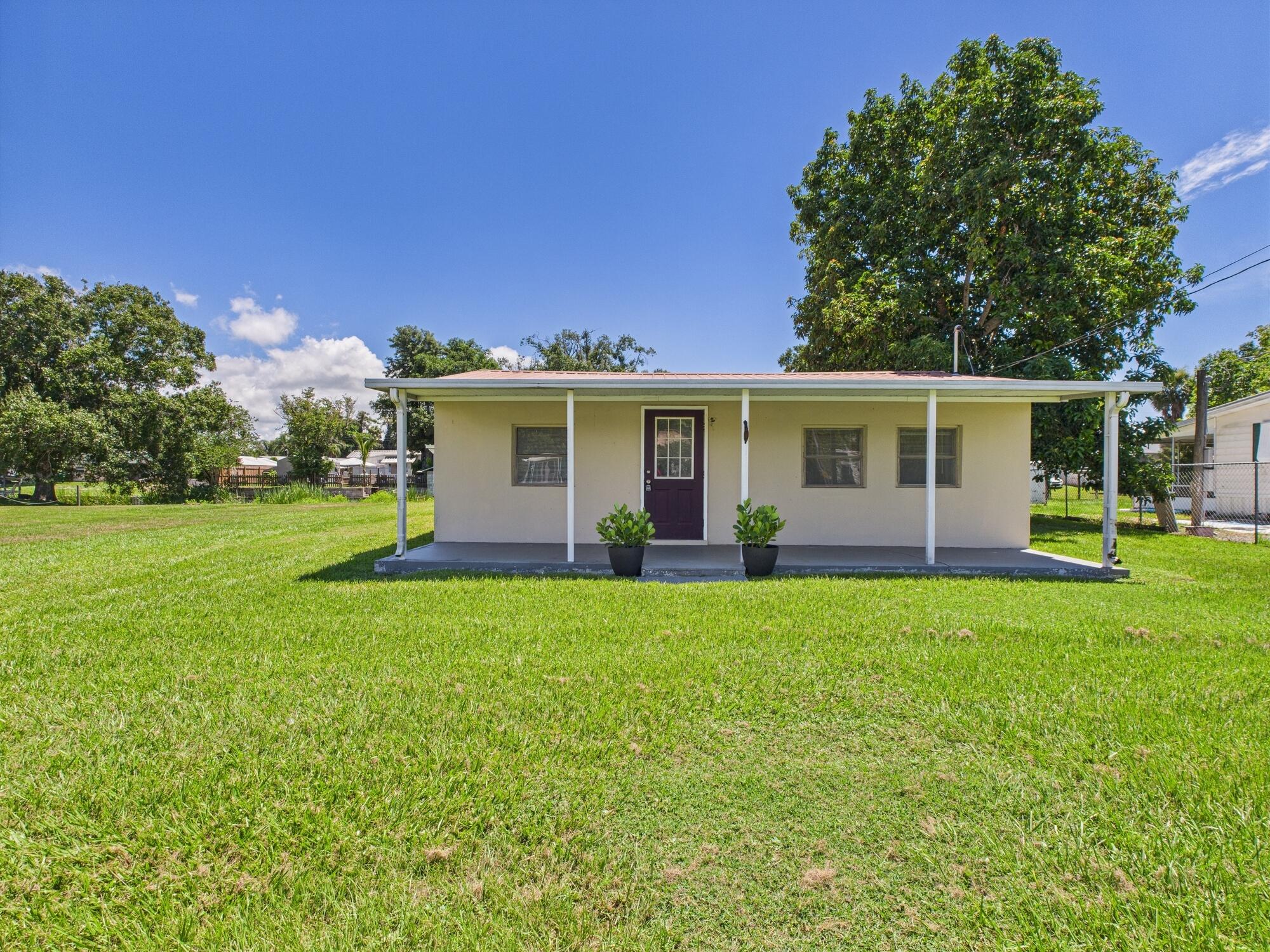 3302 Southeast 34th Avenue Okeechobee, FL 34974 - Photo 1 of 54 a view of a house with backyard and garden