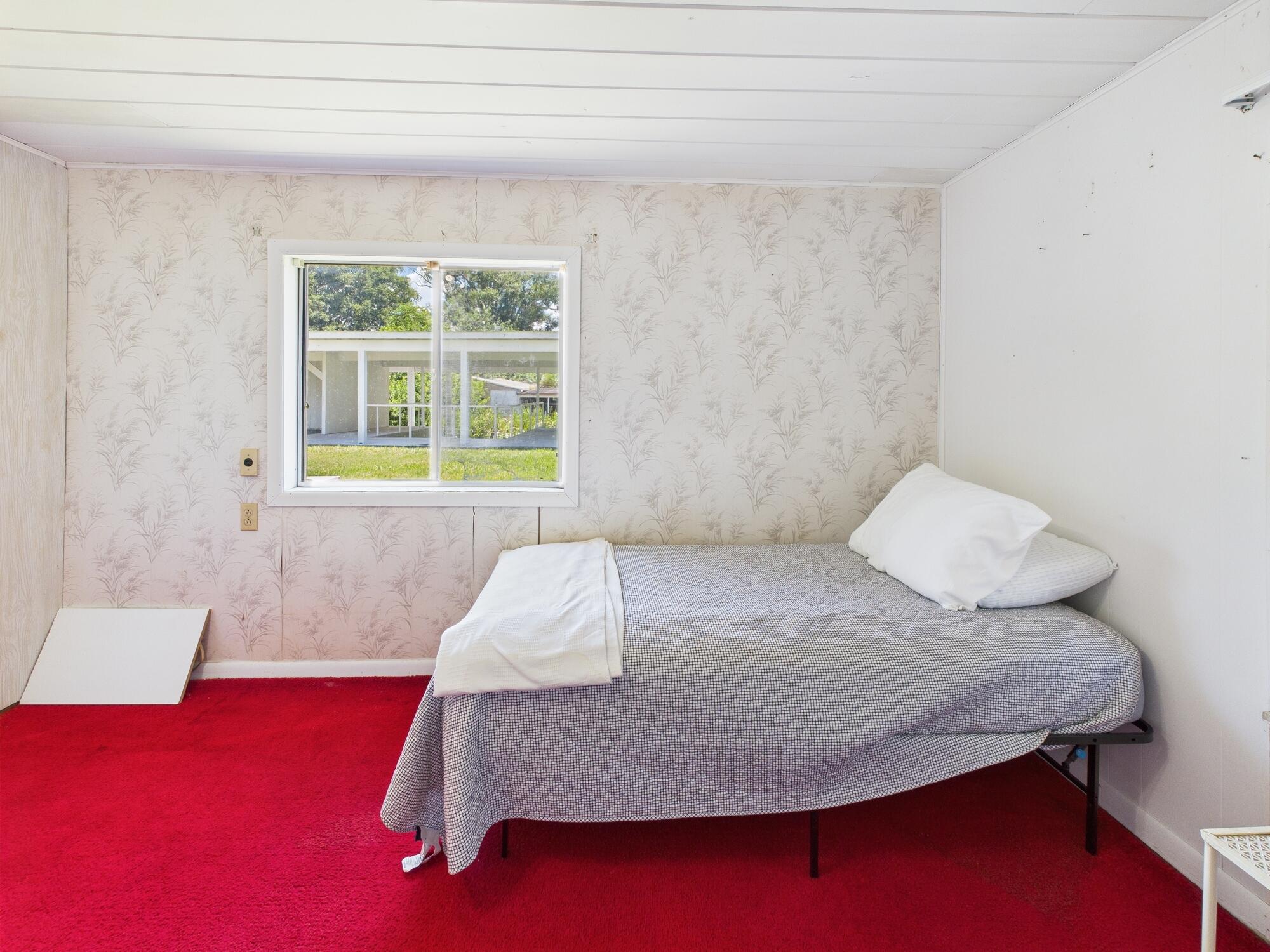 3302 Southeast 34th Avenue Okeechobee, FL 34974 - Photo 19 of 54 a bedroom with a bed and window