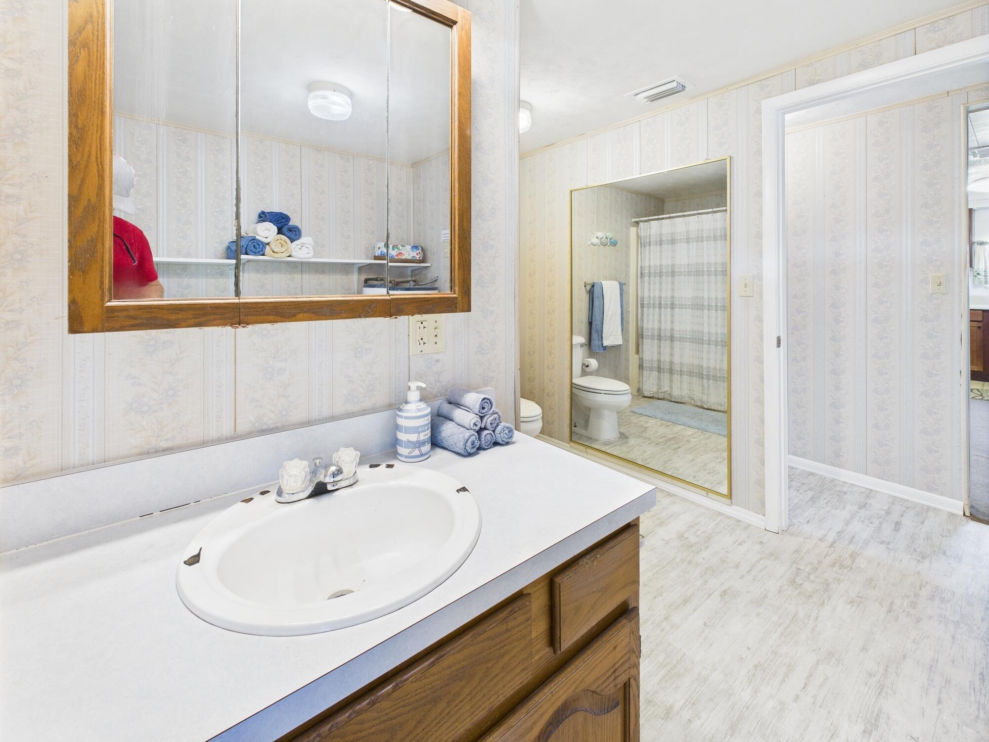 3302 Southeast 34th Avenue Okeechobee, FL 34974 - Photo 26 of 54 a bathroom with a sink and a mirror
