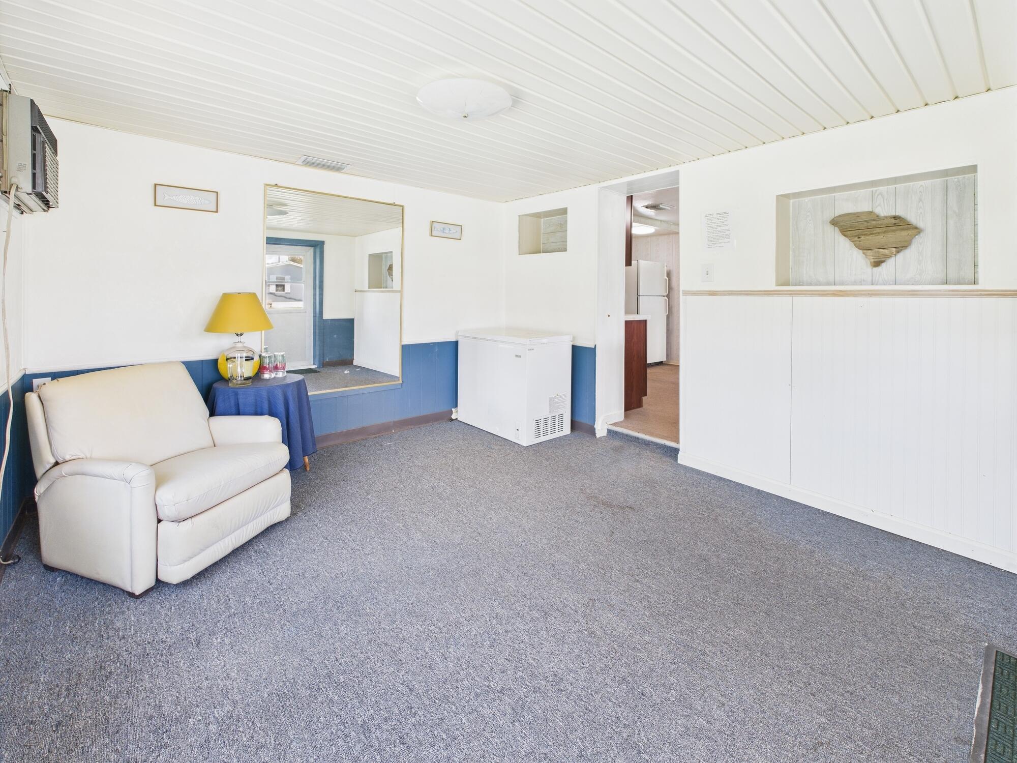 3302 Southeast 34th Avenue Okeechobee, FL 34974 - Photo 29 of 54 a living room with furniture and paintings on the wall