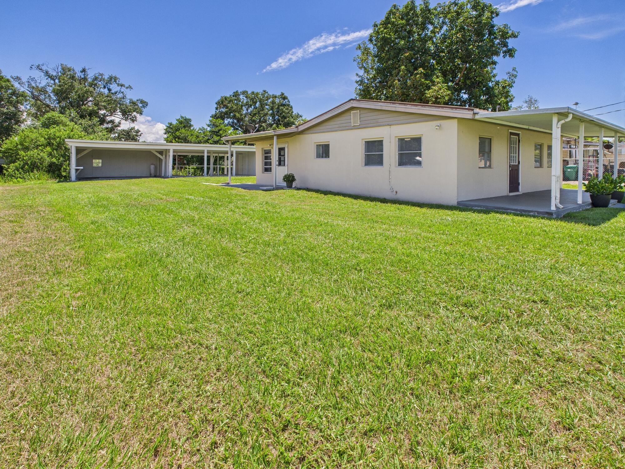 3302 Southeast 34th Avenue Okeechobee, FL 34974 - Photo 34 of 54 a view of house with a yard and potted plants