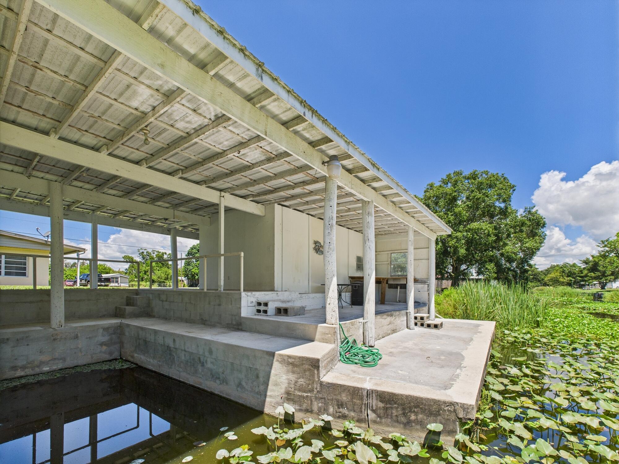 3302 Southeast 34th Avenue Okeechobee, FL 34974 - Photo 44 of 54 a view of a patio with couches table and chairs and potted plants