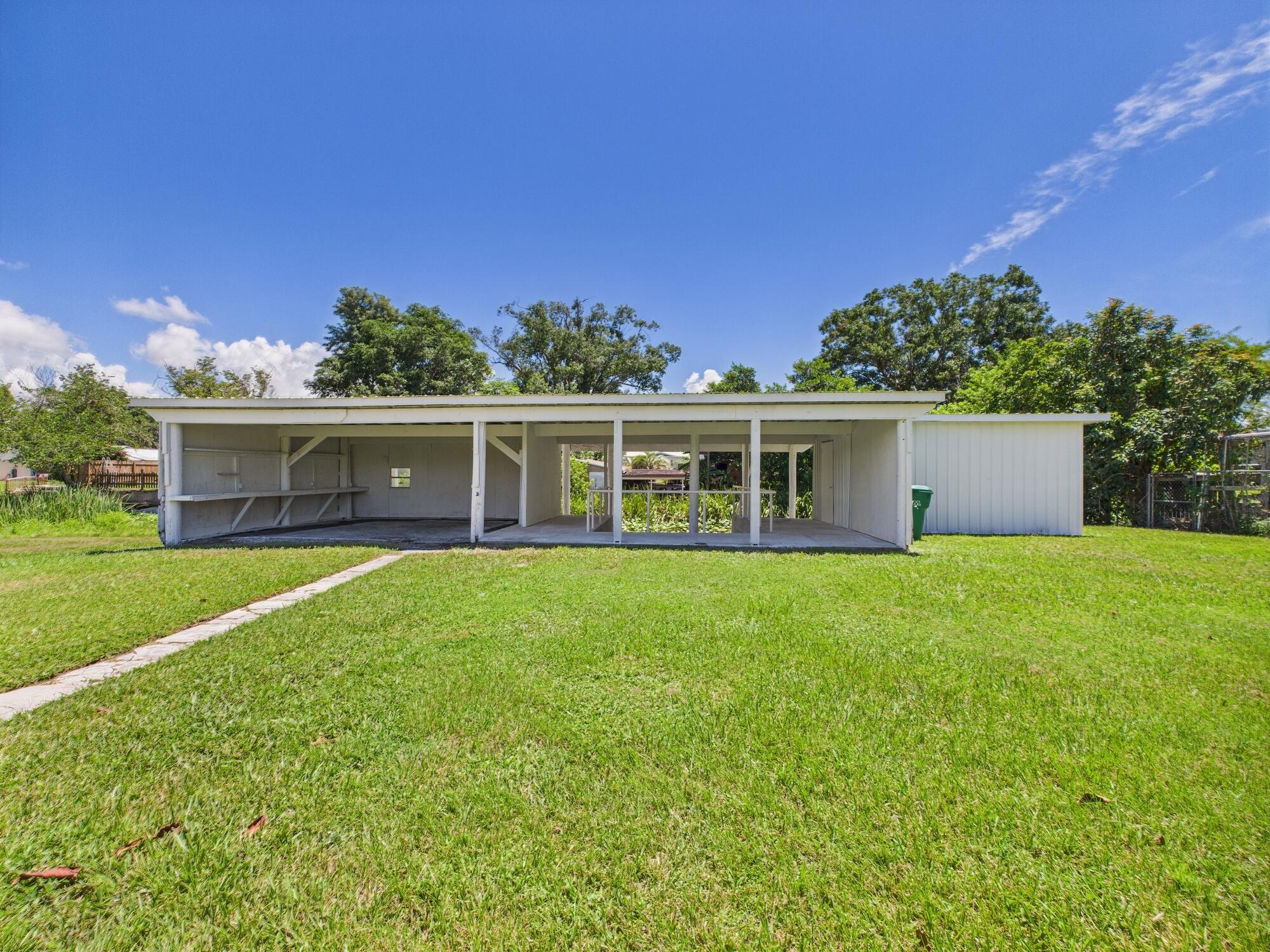 3302 Southeast 34th Avenue Okeechobee, FL 34974 - Photo 50 of 54 a view of a house with a yard and sitting area