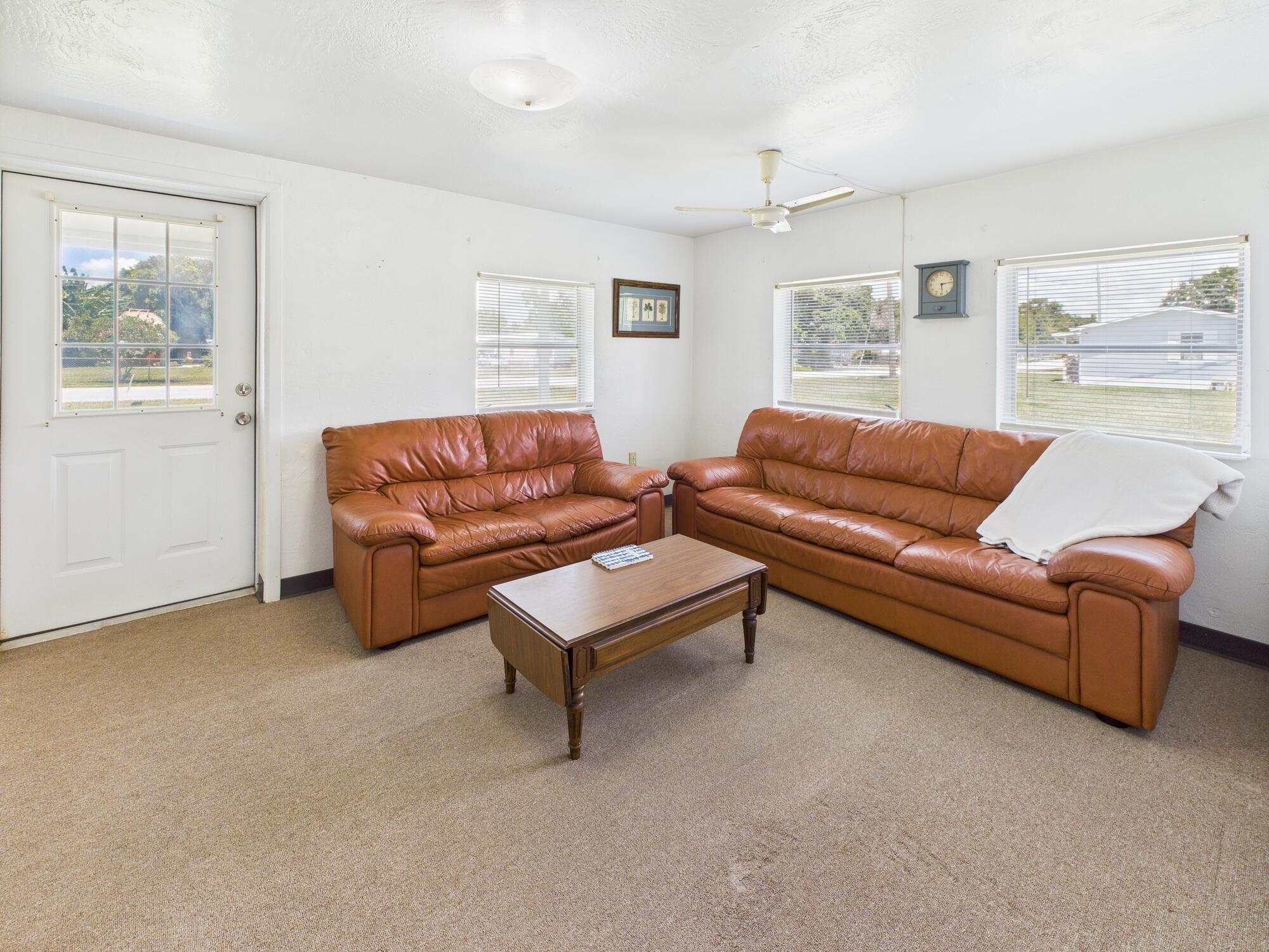 3302 Southeast 34th Avenue Okeechobee, FL 34974 - Photo 8 of 54 a living room with furniture and a window