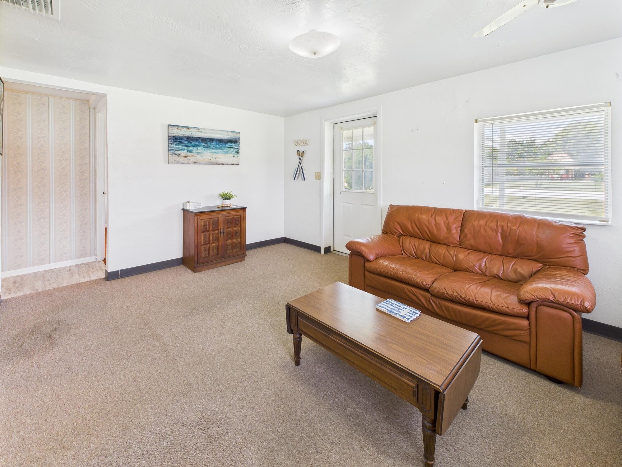 3302 Southeast 34th Avenue Okeechobee, FL 34974 - Photo 9 of 54 a living room with furniture and a window