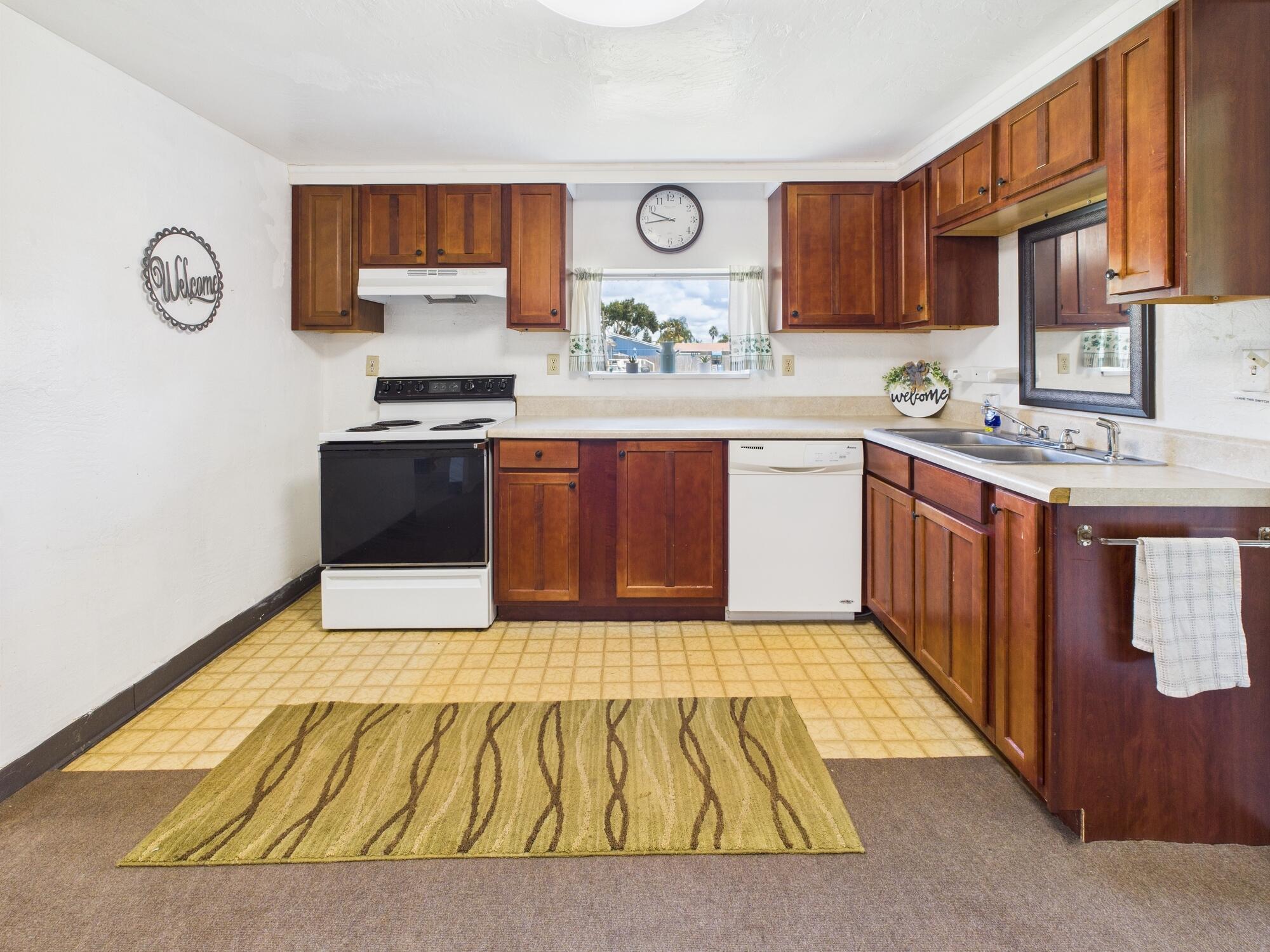 3302 Southeast 34th Avenue Okeechobee, FL 34974 - Photo 10 of 54 a kitchen with stainless steel appliances granite countertop a stove sink and cabinets