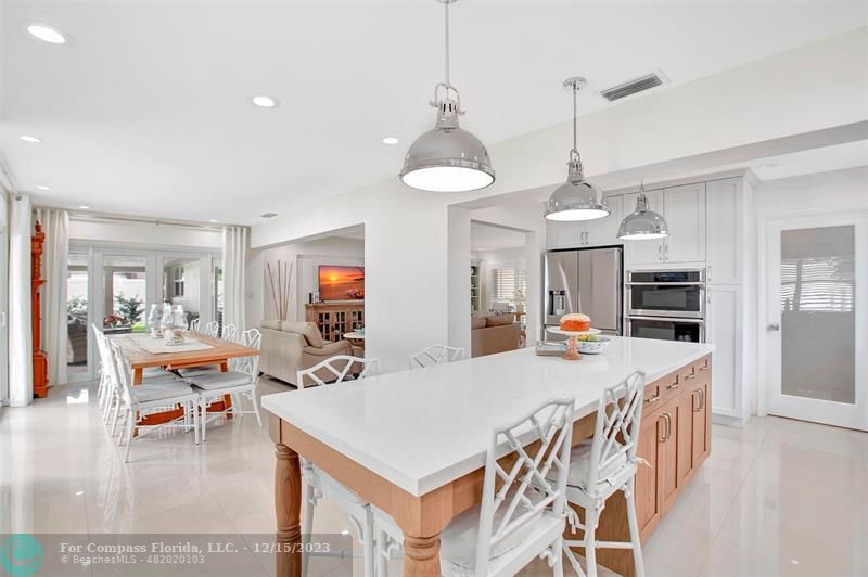1985 Sailfish Place Pompano Beach, FL 33062 - Photo 17 of 47 a view of a dining room and livingroom with furniture wooden floor a chandelier