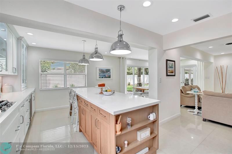 1985 Sailfish Place Pompano Beach, FL 33062 - Photo 18 of 47 a kitchen with kitchen island a sink appliances and a counter top space