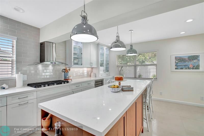 1985 Sailfish Place Pompano Beach, FL 33062 - Photo 19 of 47 a kitchen with stainless steel appliances granite countertop a sink a stove a refrigerator a center island a stove and a window