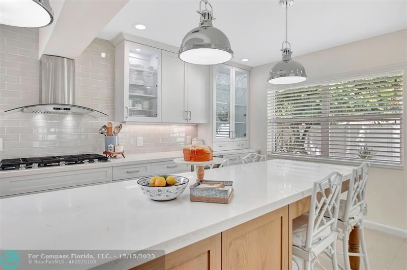 1985 Sailfish Place Pompano Beach, FL 33062 - Photo 20 of 47 a kitchen with a stove a sink and a wooden floor