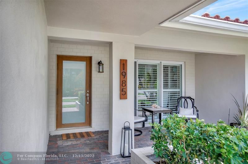 1985 Sailfish Place Pompano Beach, FL 33062 - Photo 2 of 47 front view of a house with a bench