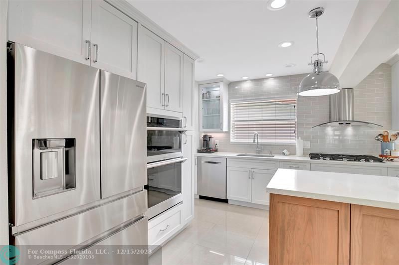 1985 Sailfish Place Pompano Beach, FL 33062 - Photo 22 of 47 a kitchen with a sink stove and refrigerator