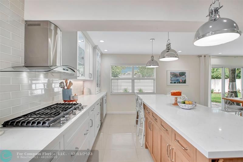 1985 Sailfish Place Pompano Beach, FL 33062 - Photo 25 of 47 a kitchen with stainless steel appliances a sink stove and cabinets