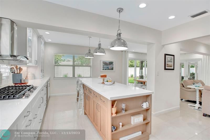 1985 Sailfish Place Pompano Beach, FL 33062 - Photo 26 of 47 a kitchen that has a lot of cabinets a sink and a wooden floor