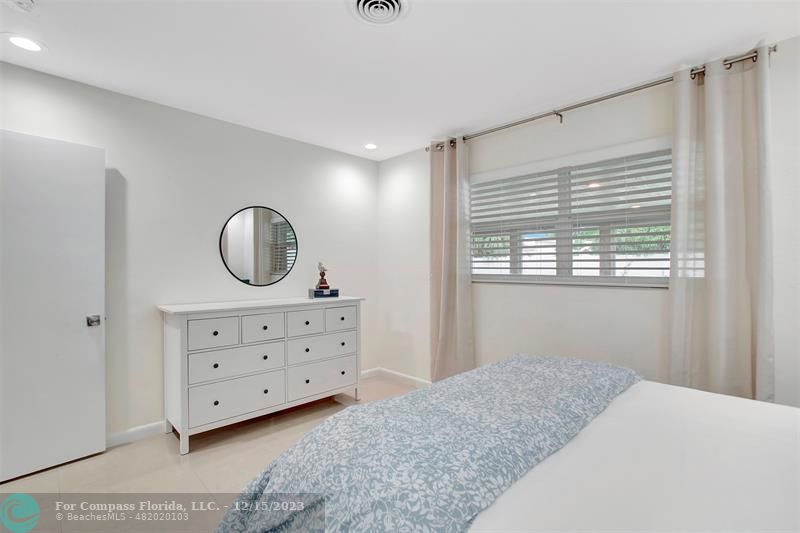 1985 Sailfish Place Pompano Beach, FL 33062 - Photo 32 of 47 a bedroom with a bed and a dresser